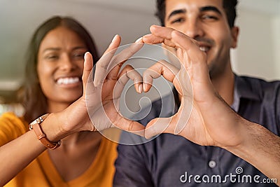Indian couple making heart with hands Stock Photo
