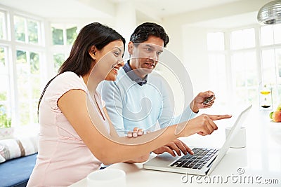 Indian Couple Making Online Purchase At Home Stock Photo