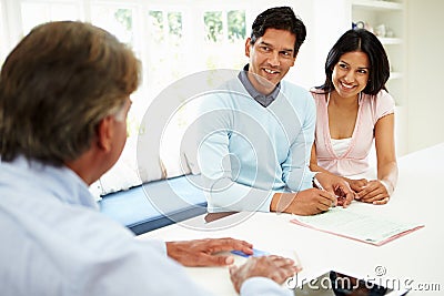 Indian Couple Meeting With Financial Advisor At Home Stock Photo