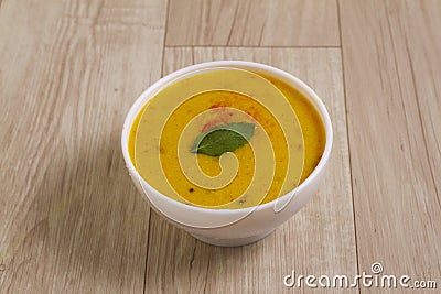 Indian Cuisine Kadhi - Vegetarian Curry Made of Buttermilk And Chick Pea Flour. served in a bowl or Karahi over wooden background Stock Photo