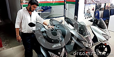 automobile customer touching latest model of motorcycles at bajaj showroom showroom in India aug 2019 Editorial Stock Photo