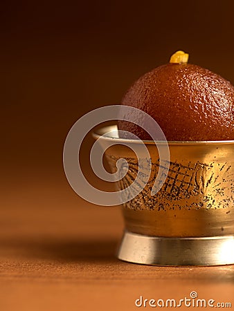 Gulab Jamun in copper antique bowl with spoon, Indian Dessert or Sweet Dish Stock Photo
