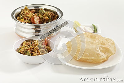 Indian dish Mixed vegetables along with Puri the fried Indian bread. Stock Photo