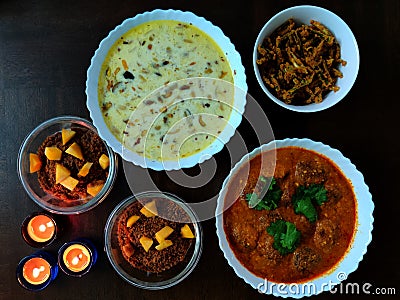 Indian Dishes, Dessert and Three Candles, Kurkuri Bhindi or Crispy Okra, Kheer or Indian Rice Pudding with dry fruits, Malai Kofta Stock Photo