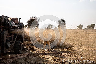 Indian farmer harvesting crop in thrashing machine Editorial Stock Photo