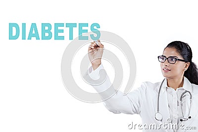 Indian female doctor writing diabetes word Stock Photo