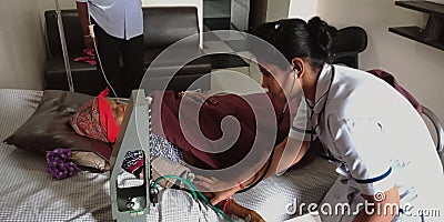 An indian female nurse staff checking blood pressure to the women patient Editorial Stock Photo