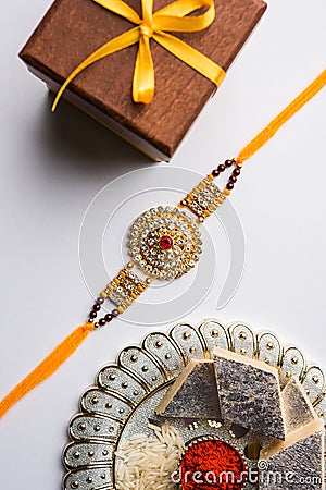 Indian festival Raksha bandhan celebrated with a designer thread, sweets between brothers and sisters of all ages Stock Photo