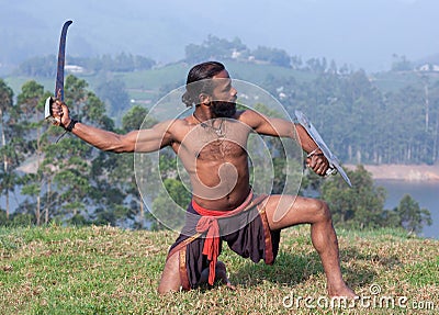 Indian fighter performing Kalaripayattu marital art demonstration in Kerala, India Stock Photo