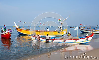 Indian fishermen catching fish for food in wooden boats in Arabian sea, Kerala, South India Editorial Stock Photo