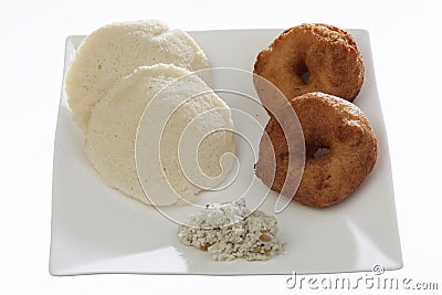 Indian fried snack medu vada & idli with coconut chutney and sambhar. Stock Photo