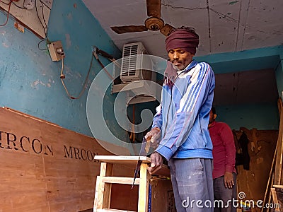 an indian furniture making man working at wooden factory in India January 2020 Editorial Stock Photo