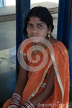 Indian girl sitting waiting the train. Editorial Stock Photo
