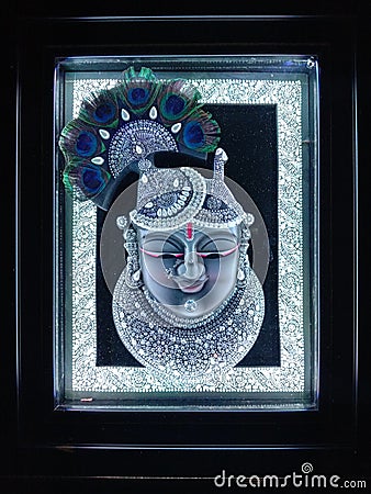Indian God Shrinathji photo frame with background of white light and peacock feathers Editorial Stock Photo