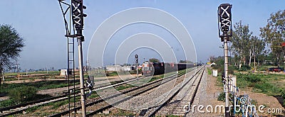 Indian Goods train with trees on both sides of track Stock Photo