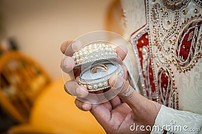 Indian groom holding ring Stock Photo