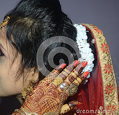 An Indian groom showing het beautiful white gajra, flowers on her head closeup shot Stock Photo
