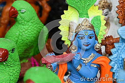 Indian handicraft statue of god Lord Krishna, many handmade colorful sculptures of Hindu god Stock Photo