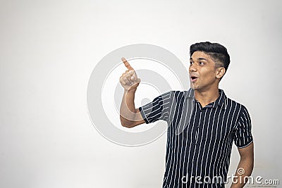 An indian handsome asian man wearing black shirt with white line and shocking expression on a white background Stock Photo