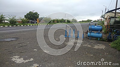 Indian highway and a road side puncture repair shop with all sizes of jacks for trucks and heavy vehicles Editorial Stock Photo