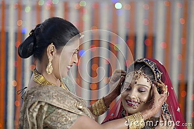 Indian Hindu Bride getting ready with help of moth Stock Photo