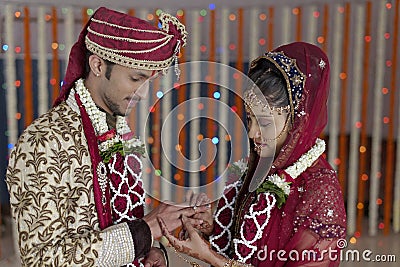 Indian Hindu Bride & Groom a happy smiling couple exchanging wedding ring. Stock Photo