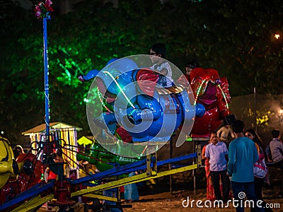 Indian kids enjoying carousel ride in elephant at amusement park Editorial Stock Photo