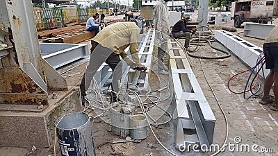 Indian laborers doing welding work Editorial Stock Photo