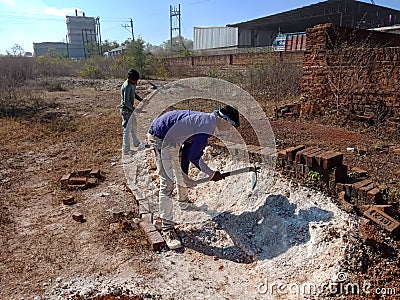 indian labours digging lime soil for construction work in India dec 2019 Editorial Stock Photo