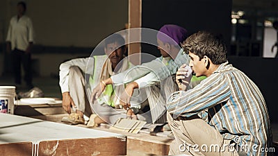 Indian labours on tea break during work Editorial Stock Photo