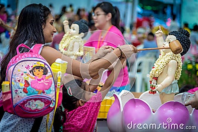 Indian Lady with Daughter Bathing the Buddha During Vesak Day Editorial Stock Photo