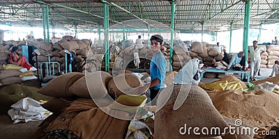 An indian little boy holded wheat sack at wholesale godown Editorial Stock Photo