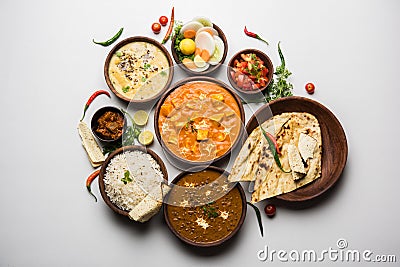 Indian lunch or dinner items like dal, paneer butter masala, roti, rice, salad Stock Photo