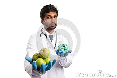Dietician holding apples and measuring tape Stock Photo