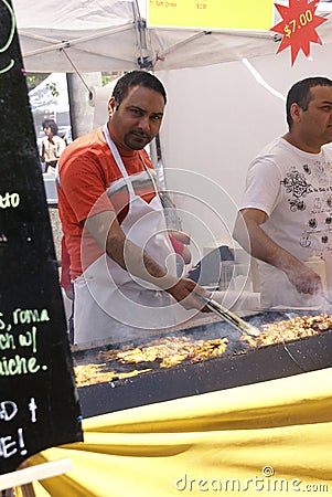 Indian man cooking spicy kebabs Editorial Stock Photo