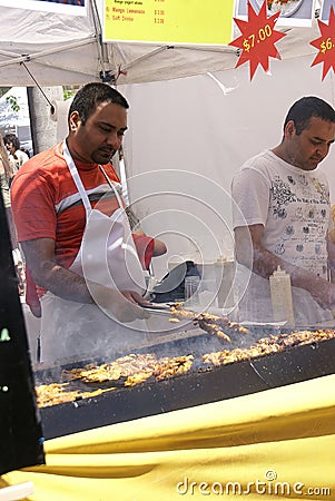 Indian man cooking spicy kebabs Editorial Stock Photo