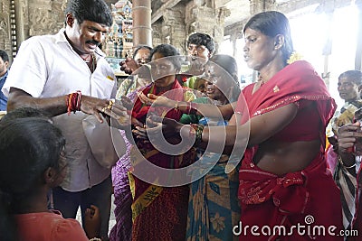 Indian man gives laddu treats to pilgrims Editorial Stock Photo