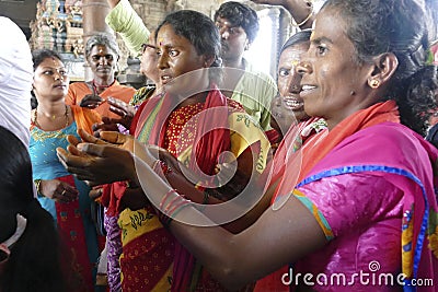 Indian man gives laddu treats to pilgrims Editorial Stock Photo