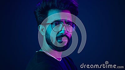 Indian man guy profile turning head looking camera serious developer coding internet technology hacker programmer Stock Photo