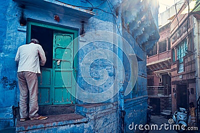 Indian man and his blue house in streets, Jodhpur, Rajasthan, India Editorial Stock Photo