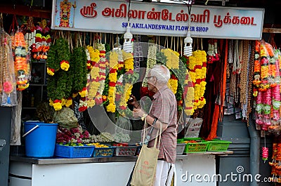 Indian man at Little India flower garland shop Singapore Editorial Stock Photo