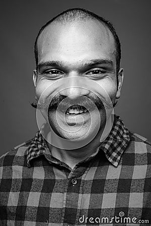 Indian man with mustache against gray background Stock Photo