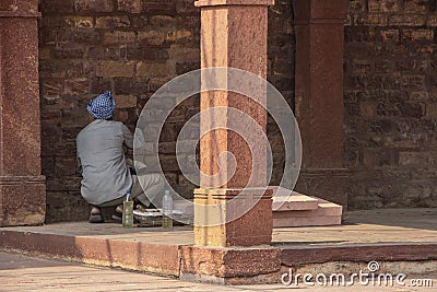 Indian man renovating a wall in a fort Stock Photo