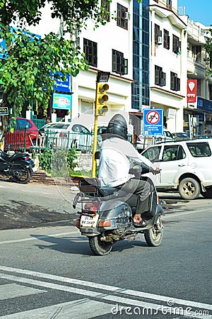 Indian man riding scooter Editorial Stock Photo