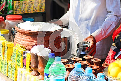 A man selling products such as Frooti, yogurt, Lassi Editorial Stock Photo
