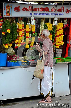 Indian man stands at Little India flower garland shop Singapore Editorial Stock Photo