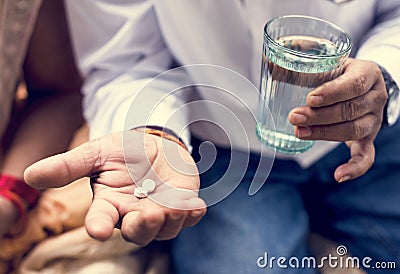 Indian man taking tablets medicine Stock Photo