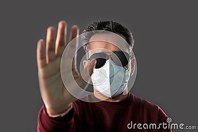 Indian Man wearing a N95 mask and sunglasses showing hands to stop virus, dust, pollution and smog Stock Photo