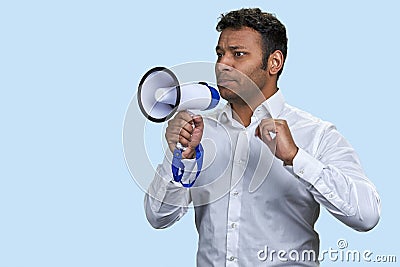 Indian man in white shirt holding a megaphone. Stock Photo