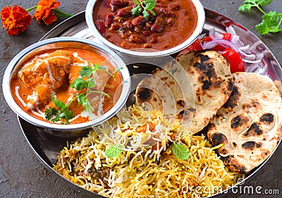 Indian non-vegetarian Meal -Butter Chicken, rajma, biryani with roti and salad Stock Photo